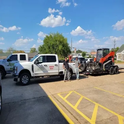Disaster relief crew with trucks and skid steer